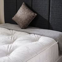 close up of charcoal headboard of bed