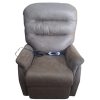 A gray upholstered recliner chair with a matching remote control resting on the seat, shown against a plain white background.