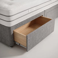 storage draws on grey fabric bed