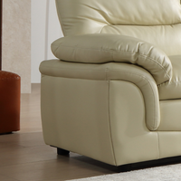 Beige leather sofa with a cushion in a room setting
