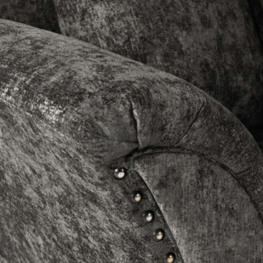 Close-up of a textured gray fabric surface with decorative studs.