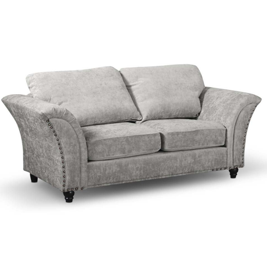 Gray sofa with nailhead trim on a white background