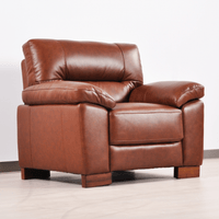 Dalmore Tan Armchair – Angled view in a cozy room setting, highlighting warm tan fabric and modern lines.