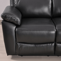 Close-up of a black leather recliner sofa on a light wooden floor.