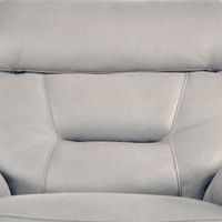 Close-up of a gray leather sofa with visible stitching