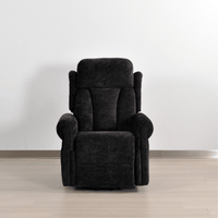 Dark gray recliner chair on a light wooden floor with a white wall background