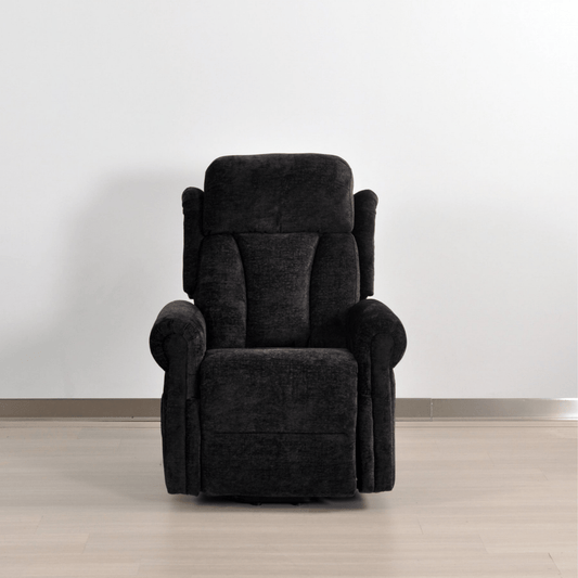 Dark gray recliner chair on a light wooden floor with a white wall background