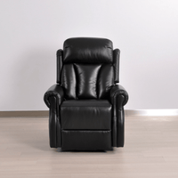 Black leather recliner chair on a wooden floor with a white wall background