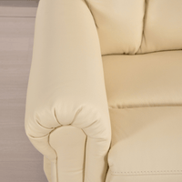 Close-up of beige upholstered furniture armrest on a neutral background