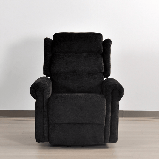 Black recliner chair on a light wooden floor with a white wall background