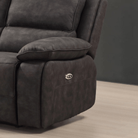 Gray recliner chair with a control panel on a wooden floor.