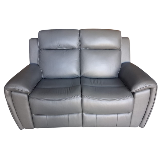 A gray leather reclining loveseat sofa with two separate seat cushions and padded armrests, shown against a plain white background.