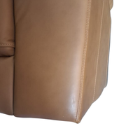 Close-up of a brown leather chair corner on a white background