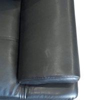 close up of black leather sofa arm
