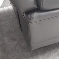 Gray leather armchair corner on a gray carpet