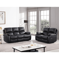Black leather recliner sofa set in a living room with a coffee table and decor items.