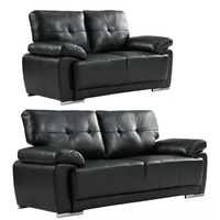 Two black leather sofas on a white background