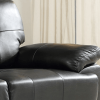 Close-up of a black leather recliner chair with a neutral background