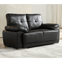 Black leather sofa in a room with light-colored walls and floor.