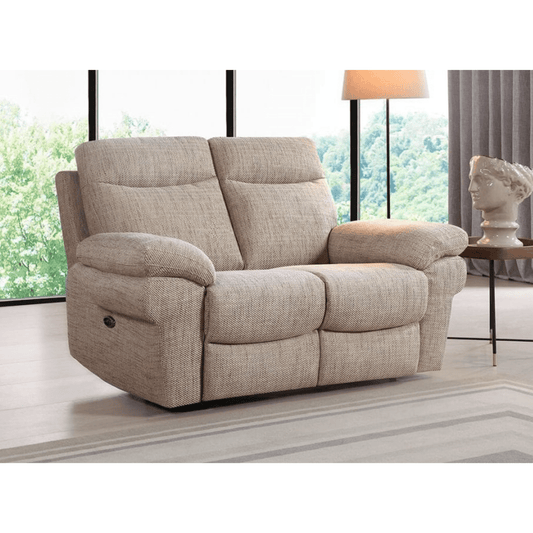 Beige recliner sofa in a living room setting with large windows and a lamp.