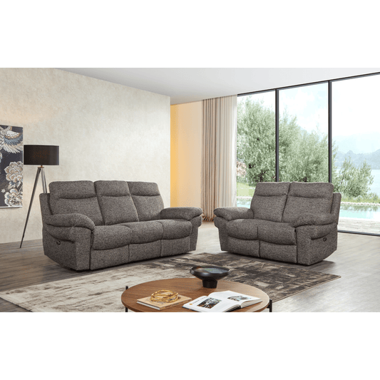 Gray sofa set in a modern living room with a view of trees and a pool.