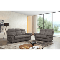 Gray sofa set in a modern living room with a view of trees and a pool.