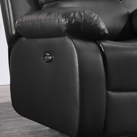 Close-up of a black leather recliner chair with a control panel.
