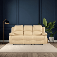 Beige sofa in a room with dark blue paneled walls, a floor lamp, and a plant.