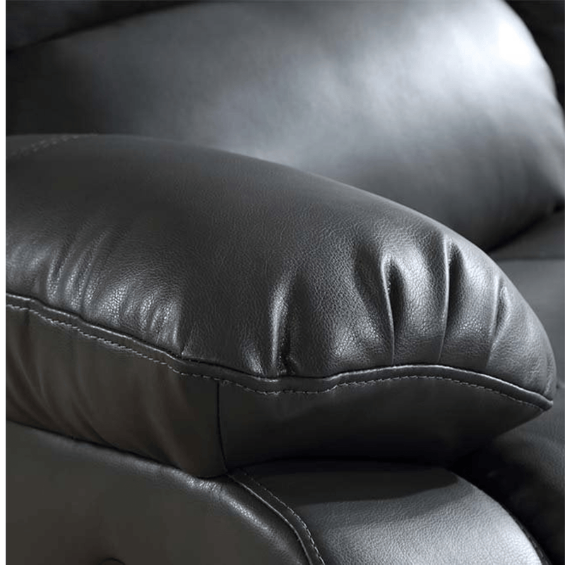 Close-up of a black leather armchair with a focus on the cushion.