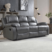 Gray reclining sofa in a living room setting with decor element