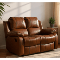 Brown leather recliner sofa in a living room setting with plants and a side table.