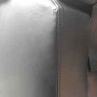 close up of leather black 3 seater sofa
