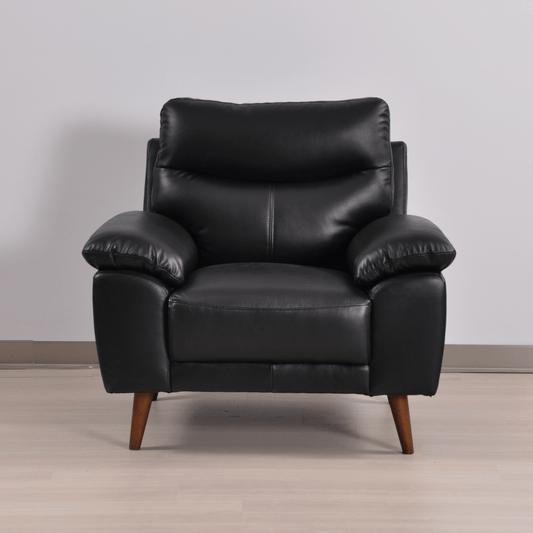 Vantage Black Armchair in a stylish living room setting with modern décor and soft lighting on a neutral background