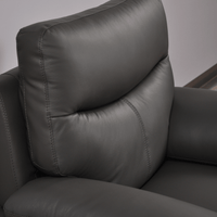 Vantage Grey Armchair close-up angled view in living room set, showcasing cushions, fabric texture, and modern design details