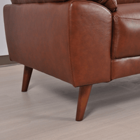 Close-up of Vantage tan armchair highlighting its plush cushions and smooth upholstery
