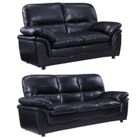 Two black leather sofas on a white background