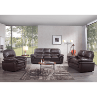 Brown leather sofa set in a modern living room with large windows.