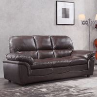 Brown leather sofa in a room with a gray wall and decorative elements.