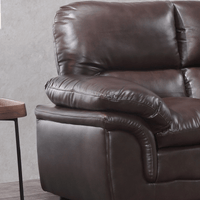 Brown leather recliner chair against a gray wall