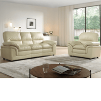 Beige leather sofa set in a living room with a coffee table and decor items.