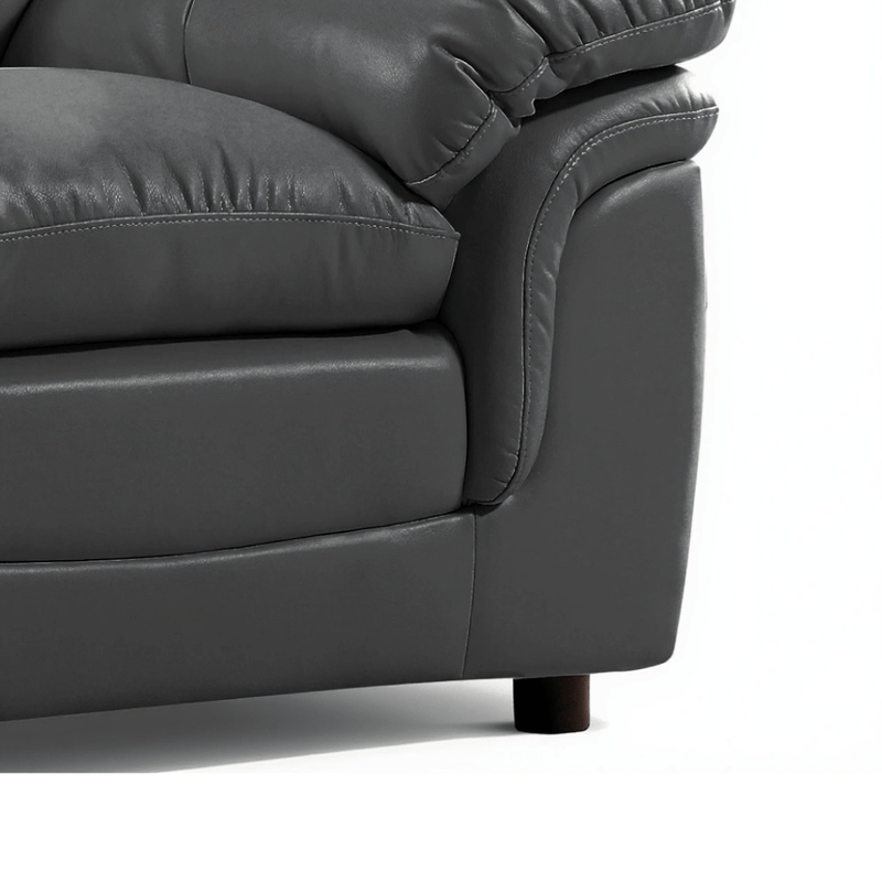 Gray leather sofa corner on a white background close up