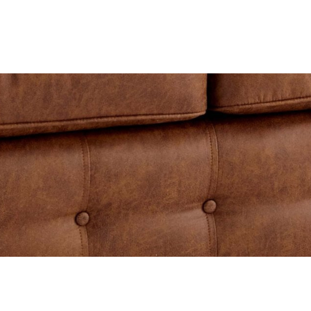 Close-up of a brown sofa with tufted design