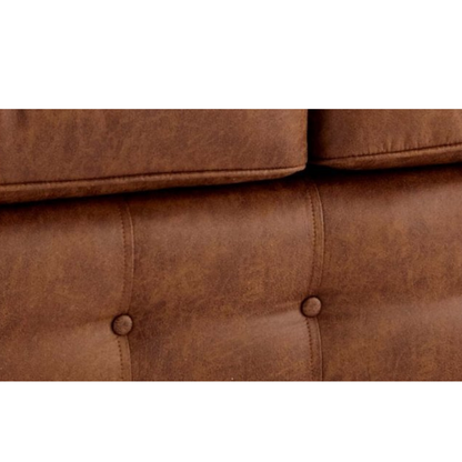 Close-up of a brown sofa with tufted design