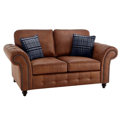 Brown sofa with plaid cushions on a white background