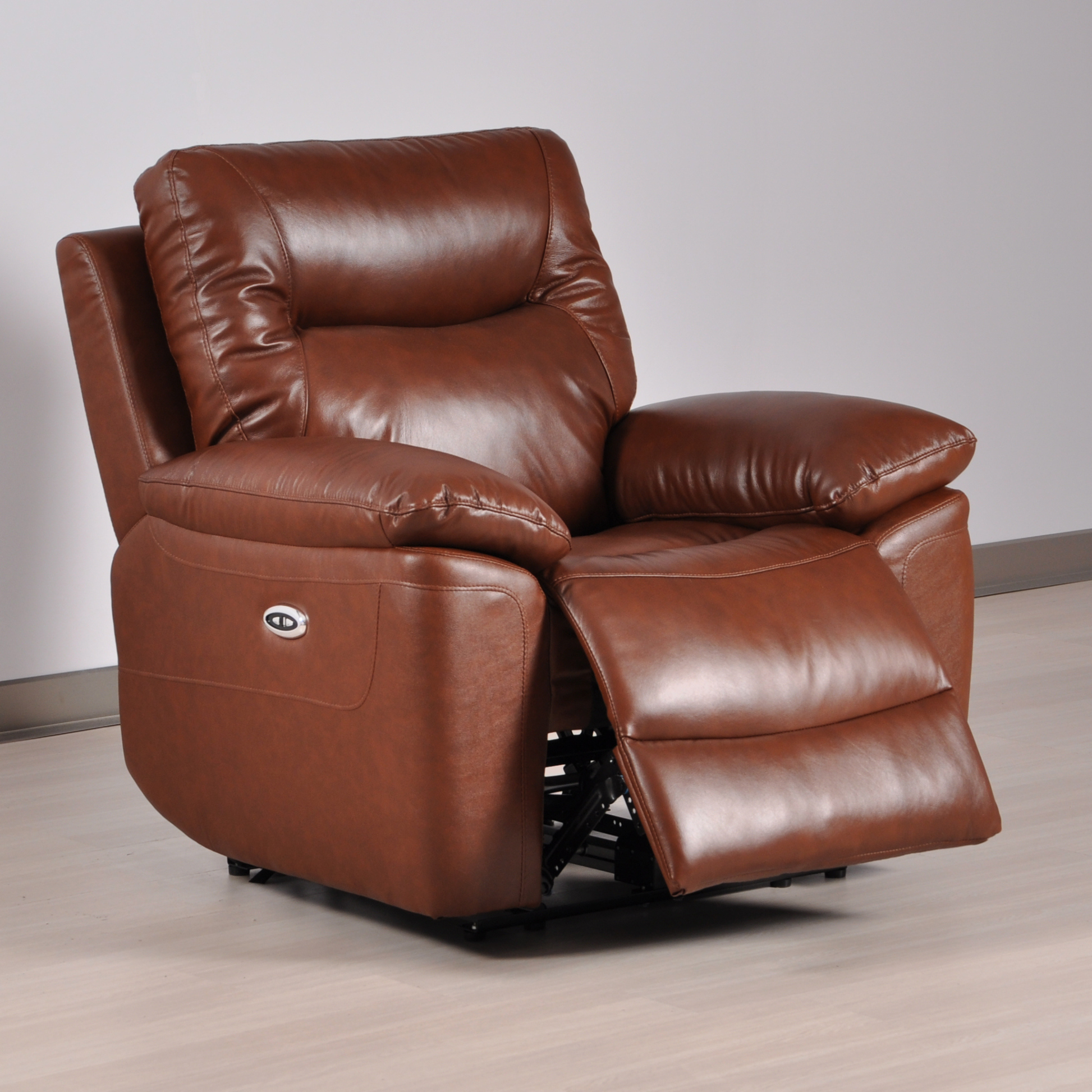 Brown leather recliner chair on a wooden floor with a neutral background