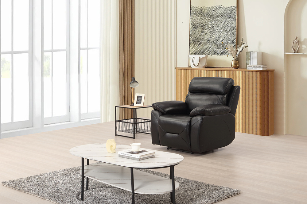 Black recliner chair in a modern living room with a coffee table and decor items.