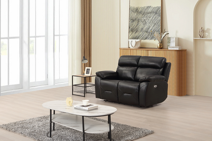 Black leather recliner chair in a modern living room with a coffee table and decor items.