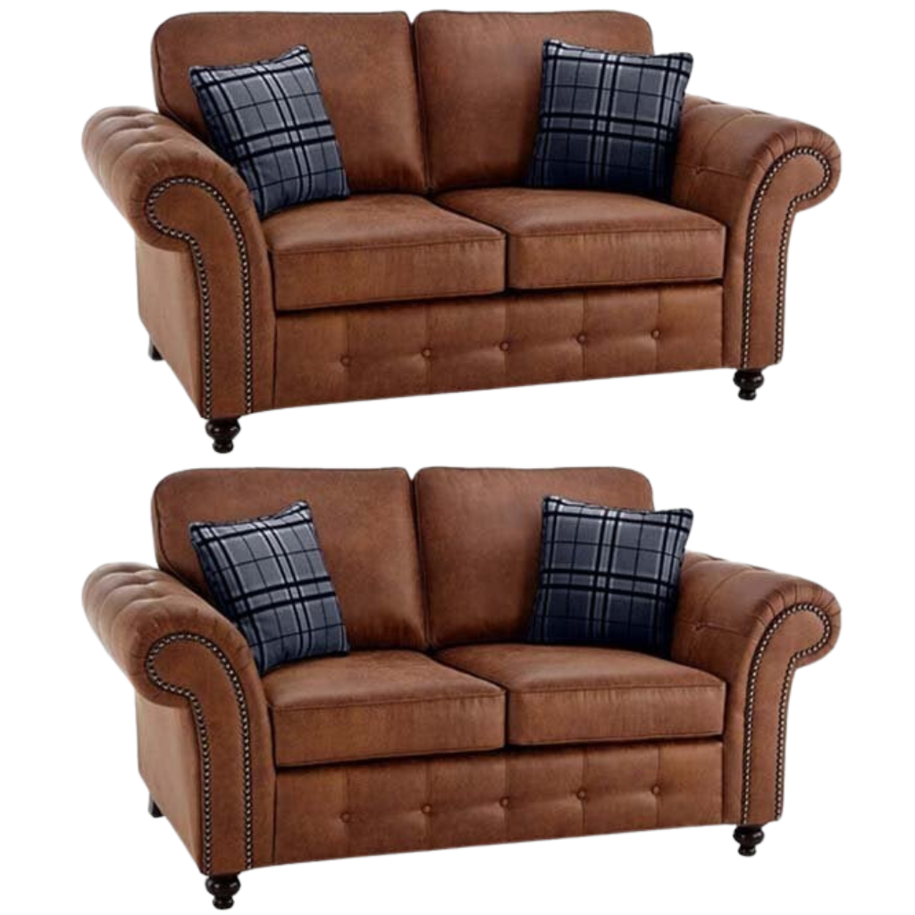 Two brown fabric  sofas with plaid cushions on a white background