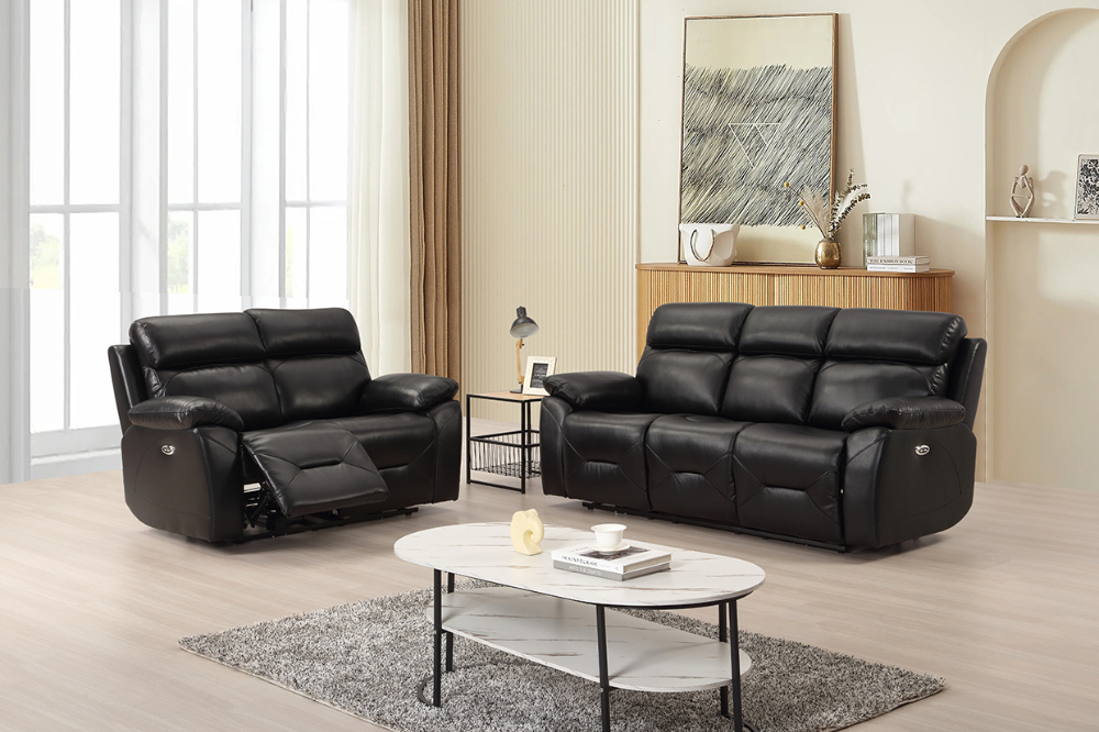 Black leather recliner sofa set in a living room with a coffee table and decor.