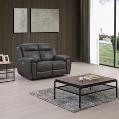 Gray recliner sofa in a living room with a coffee table and decor.